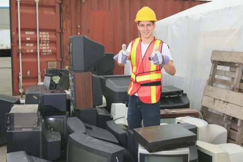 Workers sorting office furniture for reuse in Gipsy Hill clearance