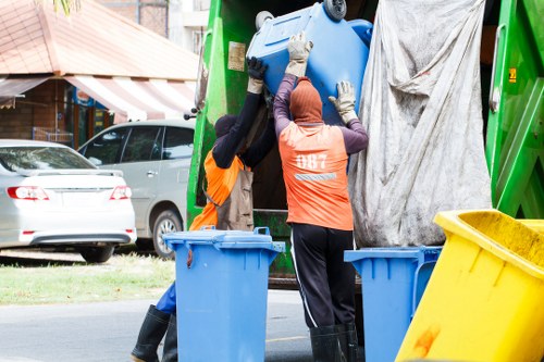 Vehicles loading sorted recyclables at a transfer station